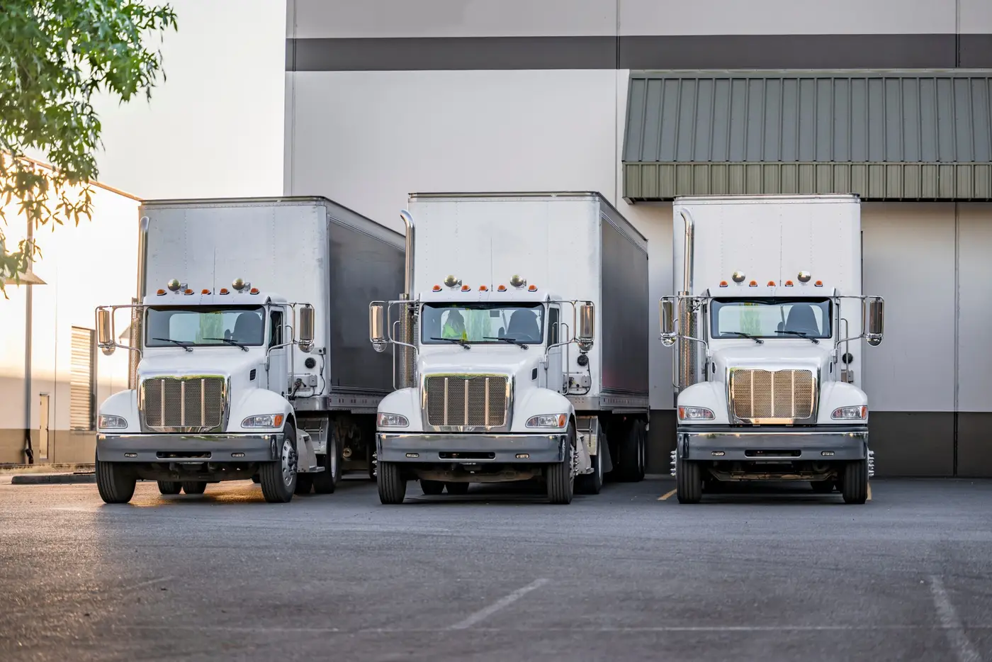 Fleet of box trucks parked at a distribution center