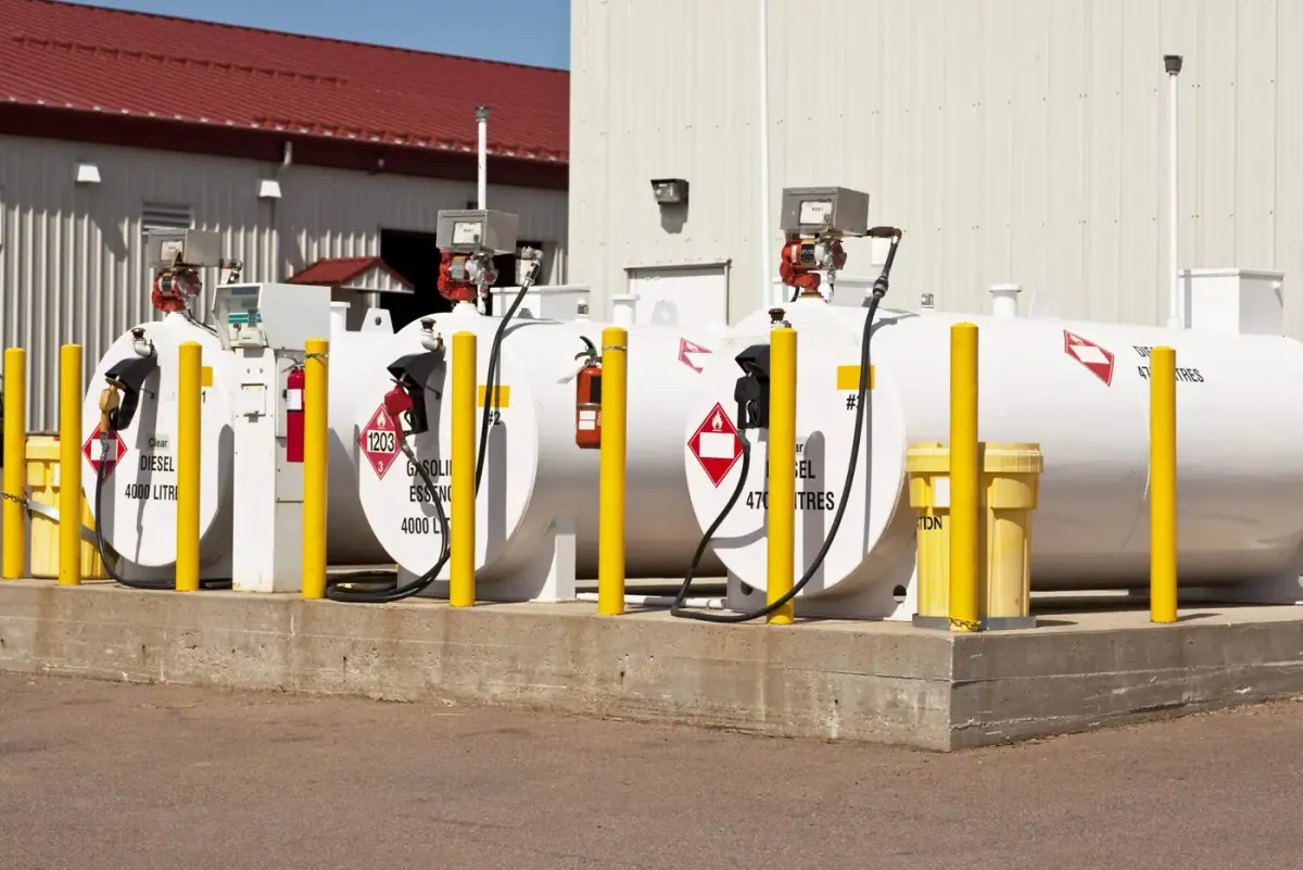 Above-ground fuel storage tanks with bollards at a commercial site