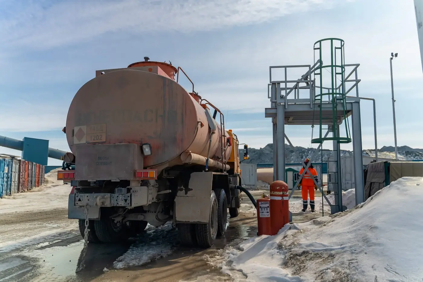 Fuel tanker truck loading at a terminal
