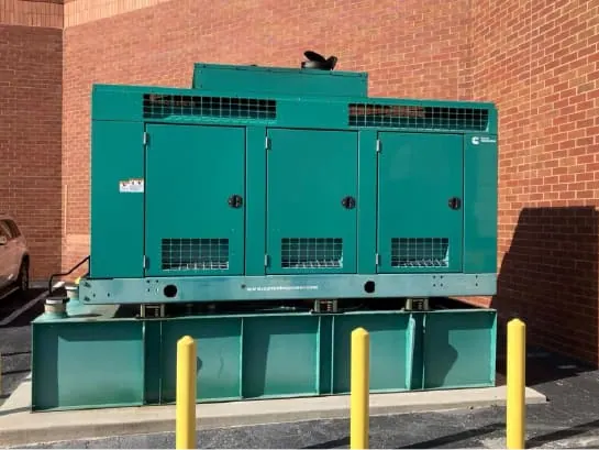 Commercial standby diesel generator on a sub-base fuel tank outside a building